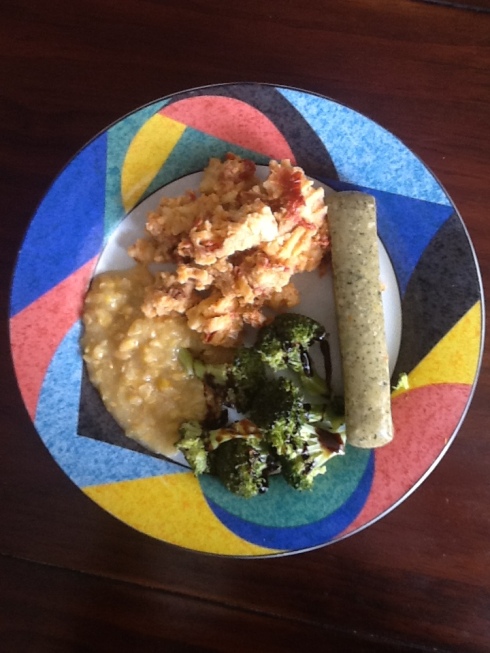 Sundried Tomato Mashed Potoates shown with creamed corn, roasted brocoli and a veggie sausage